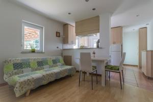 a living room and kitchen with a couch and a table at Holiday Home Neokrnjena Narava in Sevnica