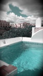 a swimming pool with a view of a city at Hotel Montelirio in Ronda