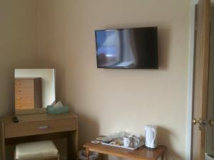 a television hanging on the wall of a room at Riverside Cottage in Lochboisdale