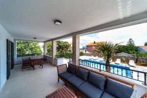 a living room with a couch and a view of a pool at Villa Christian in Malinska