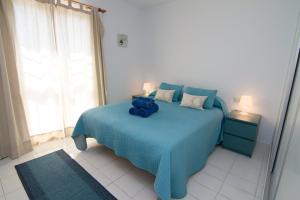 a bedroom with a blue bed with a blue teddy bear on it at BAJAMAR II 22 MENYBER in Nerja