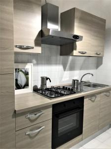 una cucina con piano cottura e lavandino di 5 Viale Fano Apartment a Rimini