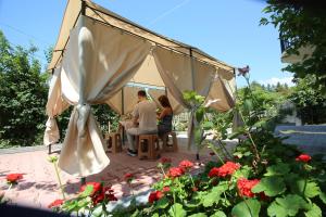 a man and a woman sitting in a gazebo at Talo's Guest House in Makhinjauri