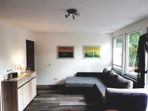 a living room with a couch and a table at Ferienhaus am Badesee Schönsee Bungalow 12 in Urnshausen