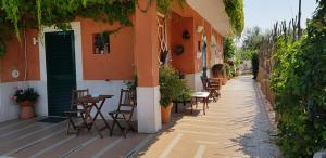 an alley with tables and chairs on a building at Casale Terra Sole B&B in Terlizzi