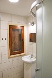 a bathroom with a sink and a mirror at Leśna Willa PTTK w Komańczy in Komańcza