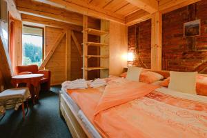 a bedroom with a bed in a log cabin at Resort Sv. František - Josefova Bouda in Špindlerův Mlýn