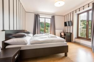 Voodi või voodid majutusasutuse Hotel Mandát toas