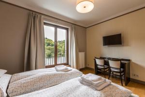 Postel nebo postele na pokoji v ubytování Hotel Mandát