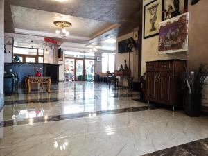 a lobby with a large tile floor in a building at Empera H-l in Sunny Beach