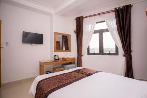 Postel nebo postele na pokoji v ubytování Phu Tho Da Lat Hotel