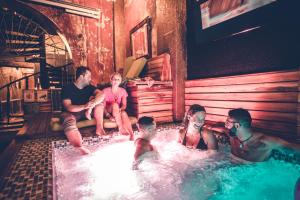 a group of people sitting in a hot tub at The Clock Hostel & Suites in Cartagena de Indias