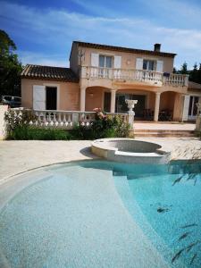 a large swimming pool in front of a house at gîte de la Rose in Draguignan