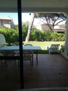 a patio with a table and chairs and a tree at Semi-Detached Villa in Vilamoura