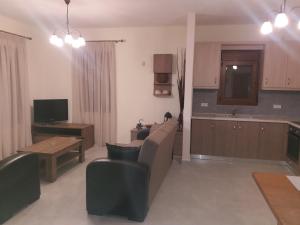 a living room with a couch and a table at Villa Anna in Ayios Nikolaos Sithonia