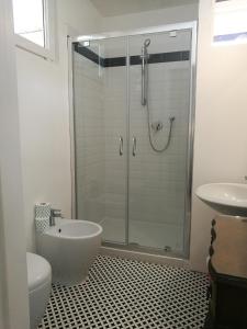 a bathroom with a shower and a toilet and a sink at Villa la Fonte in Marina di Pietrasanta
