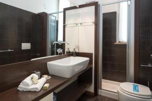 a bathroom with a sink and a toilet at Flats4Rent Casa Sailù in Verona