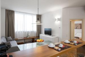 a living room with a table and a living room with a couch at Flats4Rent Casa Sailù in Verona