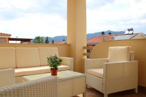 a balcony with chairs and a table and a view at La rosa dei venti in Villasimius