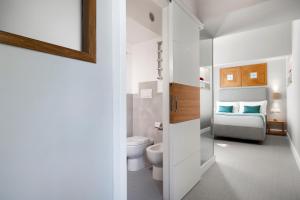 A bed or beds in a room at La Piazzetta Guest House