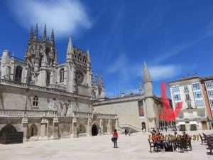 a woman is standing in front of a cathedral at VuT Plaza de la Catedral in Burgos