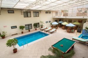 una piscina cubierta con mesa de ping pong en un edificio en Costa del Sol Wyndham Cajamarca, en Cajamarca