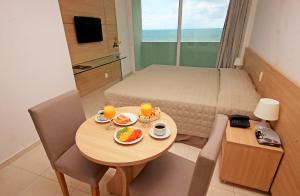a small room with a table with food on it at Hotel Jangadeiro in Recife
