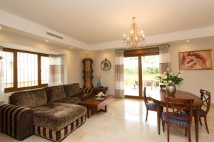 a living room with a couch and a table at Villa Las Lomas de Marbella in Marbella