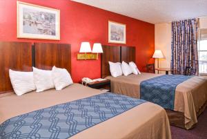 a hotel room with two beds and red walls at Americas Best Value Inn-Near NRG Park/Medical Center in Houston