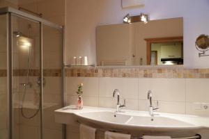 a bathroom with two sinks and a shower at Ferienwohnung Angerer in Stumm +11 photos