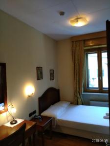 Posteľ alebo postele v izbe v ubytovaní Hotel Belvedere