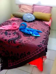 a bed with two swan towels on top of it at Verona in Paulista