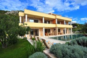 a villa with a swimming pool and a house at Villa Fora Hvar in Hvar