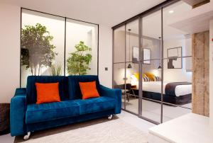 a blue couch in a room with a bedroom at Bilbao Centric Apartments in Bilbao