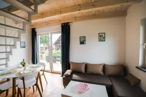a living room with a couch and a table at Domki Borys in Jastrzębia Góra