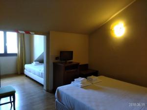 Posteľ alebo postele v izbe v ubytovaní Hotel Belvedere