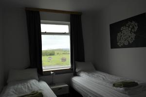 Katil atau katil-katil dalam bilik di Eidavellir Apartments and Rooms