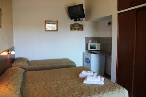 Postel nebo postele na pokoji v ubytování IRUPÉ APART HOTEL + 37 fotografií