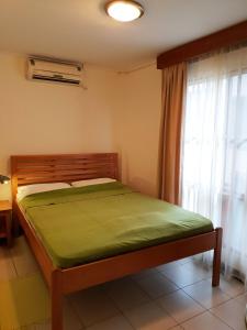 a bedroom with a bed and a window at Amalia Apartments in Paramaribo