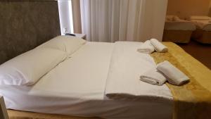 Postel nebo postele na pokoji v ubytování Hotel Righetto Fronte Mare