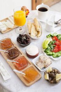 una tavola con piatti di cibo e un bicchiere di succo d'arancia di Pedieos Guest House a Lefkosa Turk
