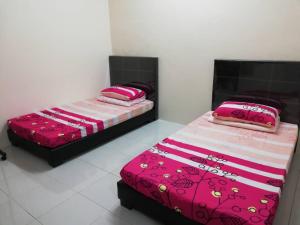 Кровать или кровати в номере J&P Homestay Sibu