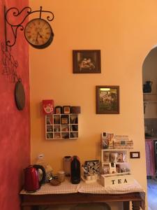 a table in a kitchen with a clock on the wall at Il Profumo del Sale in Marsala