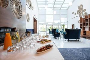 a dining room with a table with plates of food at The View Bouznika in Bouznika