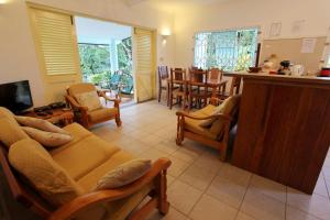 a living room with a couch and chairs and a table at Villa Kordia in Pointe Au Sel 