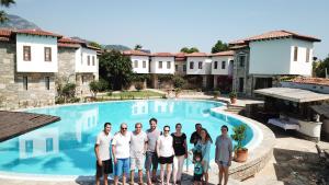 a group of people standing in front of a swimming pool at The Osmanli Hani in Dalyan