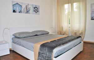 Dormitorio blanco con cama y ventana en Casa Felice, en Favaro Veneto