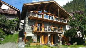 a large building with balconies and flowers on it at Chalet ZenArcs in Bourg-Saint-Maurice