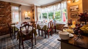 a dining room with tables and chairs and a window at Seaside Hideaway in Scarborough