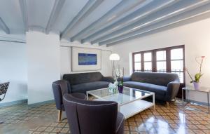 a living room with couches and a coffee table at Gran H La Marina in Altea
